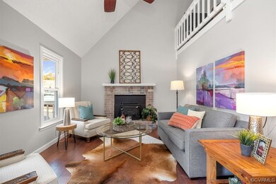 Living room with high vaulted ceiling, a fireplace