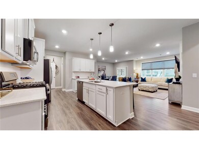 This dream kitchen features plenty of cabinet space, an oversized center island, quartz countertops, tile backsplash, walk-in pantry and the popular slate finish appliances! Photo of model home, colors and finishes will vary.
