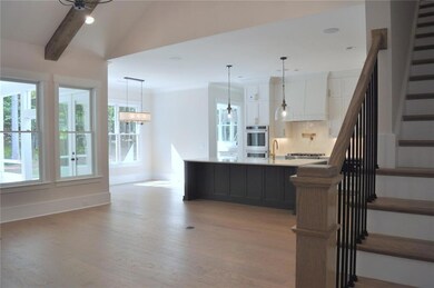 View from foyer into the open floorplan featuring vaulted great room, kitchen, scullery, and breakfast area. Representative photo of the Rebecca interior, may include additional options