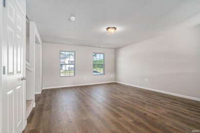 There is an abundance of natural light in the great room.  The stairs to the second floor are discreetly located, maximizing the living space.