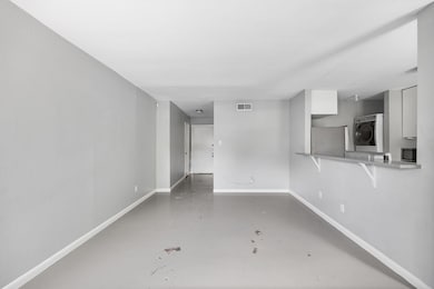 Unfurnished living room featuring concrete floori