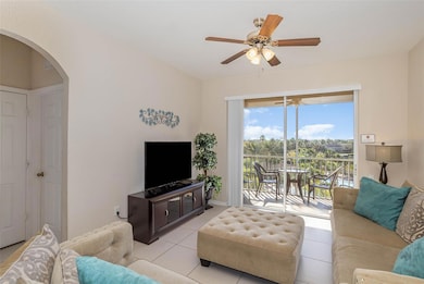 Living room with patio, enjoy views of the pool and lake!