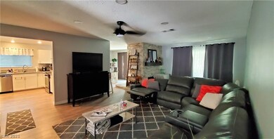 Living room with view into kitchen