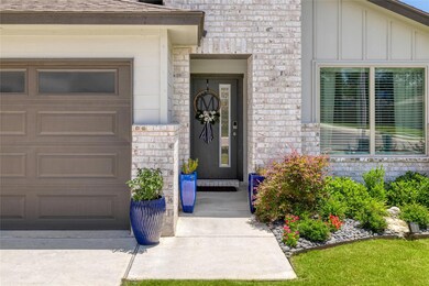 Doorway to property with brick siding, an attache