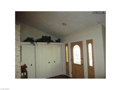 The vaulted ceiling gives the foyer and living roo