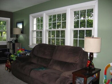 A triple window floods the living room with light 