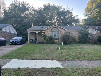 Ranch-style home with a front lawn and covered por
