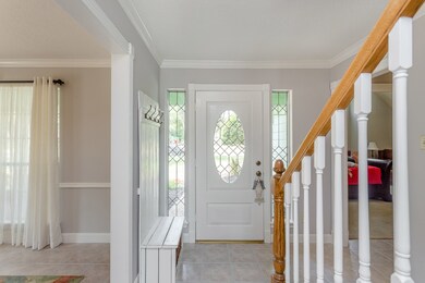 Entry with stairs up to 3 bedrooms and bath.  Right to master and powder room.  Left into dining room.  Straight ahead into living area.