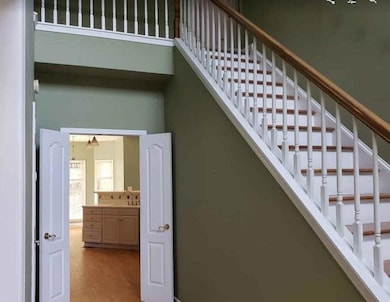 Entrance foyer featuring a high ceiling, light har