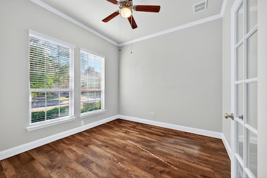 Spacious office with French doors for privacy.