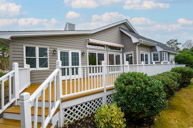 Back of property with a wooden deck