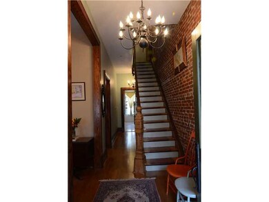 Entry/Foyer. Exposed brick and original wood stair