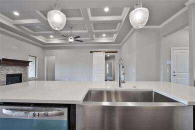 Kitchen featuring a stone fireplace, decorative li