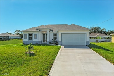 View of front of property with stucco siding, a front yard, driveway, and a garage