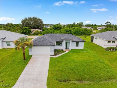 View of front of property featuring driveway, a front yard, stucco siding, an attached garage, and roof with shingles
