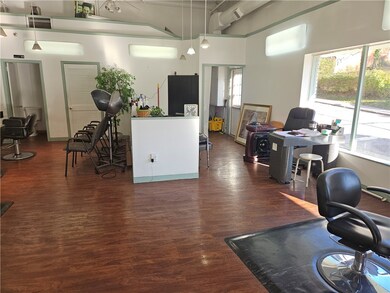 Shampoo stations at right of half wall, has multiple sinks for multiple clients at same time