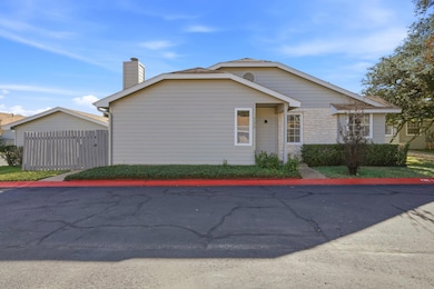 View of front of home featuring a chimney and stone siding