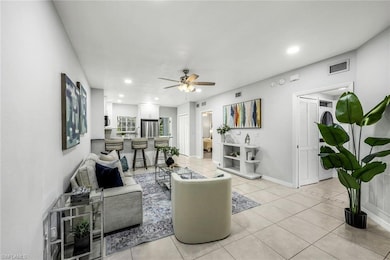 Living room with a ceiling fan, recessed lighting,
