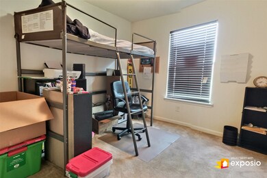 Secondary bedroom in front of home gets plenty of natural light. Closet is to the left. Currently used as office & guest room.