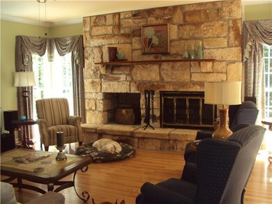 Family room is large, yet cozy with the stone wood burning fireplace, and access to the covered porch overlooking pool and hot tub.