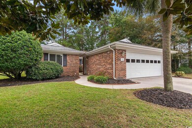 Ranch-style house with a garage and a front lawn