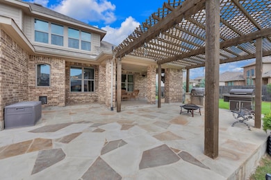 View of patio featuring a pergola, fence, a fire 