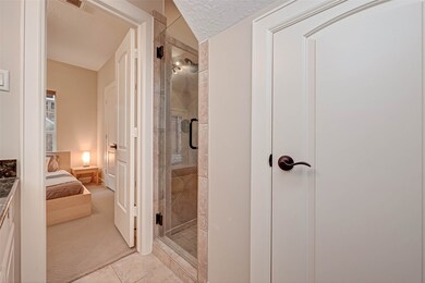 Shower has tile surround and built-in bench. Door