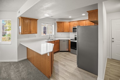 Kitchen featuring cabinetry, stainless steel appliances, new counter tops and  lighting