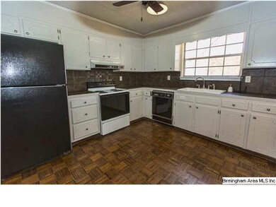 Nice, bright kitchen with parquet floor, tile back