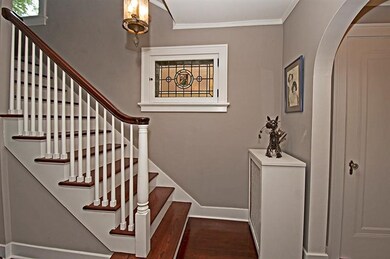 Gracious stairway with leaded stain glass and gues