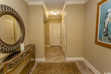 Corridor featuring crown molding and light tile pa