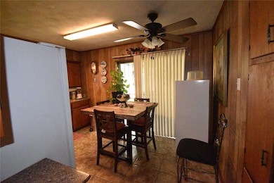 Dining space with tile patterned flooring, wood wa