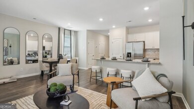 Pearson townhome living room open to a dining area with a table for family meals