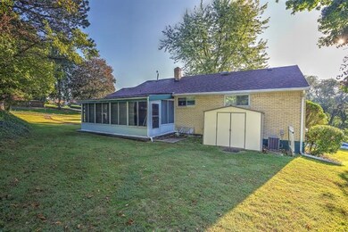 Rear exterior of home showing enclosed sunroom and