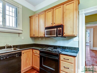 Kitchen with hardwood floor and fully equipped wit
