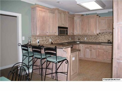 Kitchen has plenty of storage w/ eat at bar. The stainless appliances & detailed tiled backsplash define the details of this nice home.