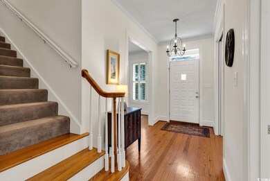 Entryway featuring crown molding, hardwood / wood-