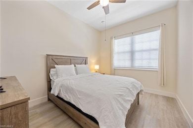 Bedroom featuring baseboards, a ceiling fan, and w