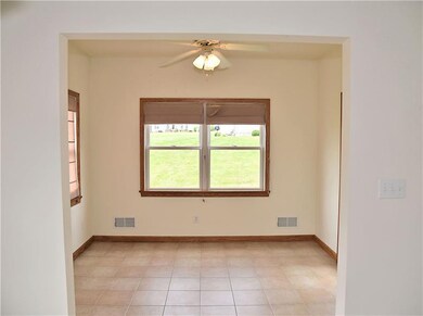 The sun room has a tiled floor that access the bac