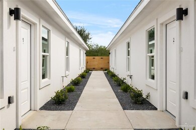 View of home's exterior featuring stucco siding and fence