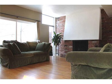 Living Room. Tons of windows, hardwood floors, and
