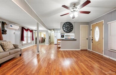 Entrance foyer with ceiling fan, a wall unit AC, and light hardwood / wood-style floors