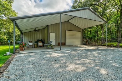 Large insulated shop with two overhead doors, one in front and one in the back.  220 Electric.