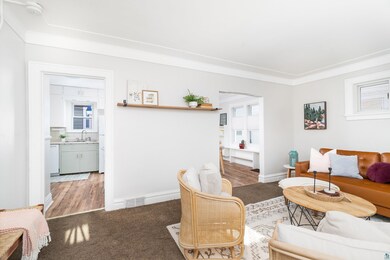 Living room with sink and ornamental molding