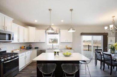 Elegant kitchen with plenty of family space! Finishes will vary.