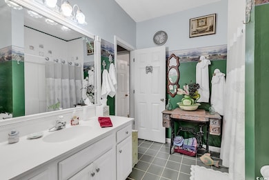 Bathroom featuring tile patterned flooring and van