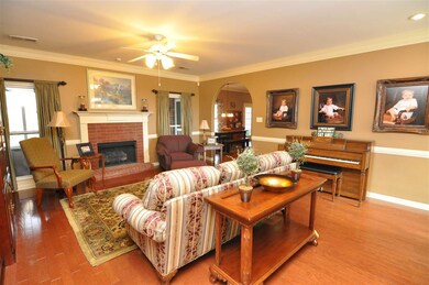 The living room is enhanced with gleaming hardwood