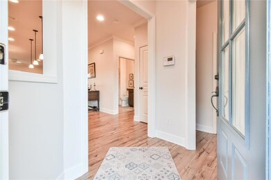Entryway featuring baseboards, ornamental molding,
