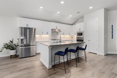 Neutral finishes in the clean, crisp kitchen.