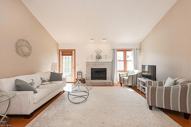 Great room with vaulted ceiling and a fireplace